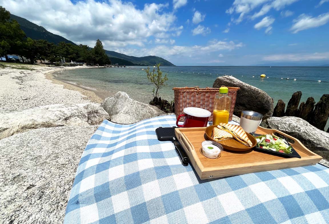 Breakfast on a sunny day on a sandy beach of Lake Biwa